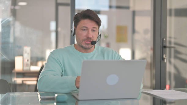 istock Call Center Employee with Headset Talking with customer Online 2150610093