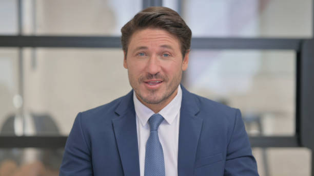 istock Portrait of Talking Middle Aged Businessman Doing Video Chat 2150610709