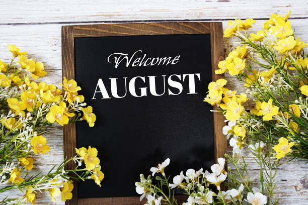 istock Welcome August text message with flower decoration on wooden background 2150612057