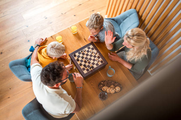 istock Brothers and Parents Engaging in a Chess Game 2150613645