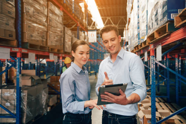 istock Warehouse manager talking and using digital tablet while checking product in warehouse. 2150613760