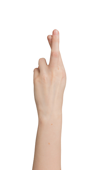 Crossing fingers for luck, hand gesture isolated on white background.