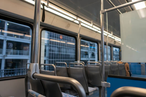 Close-up of gray handles hanging in bus. Interior of public transport. It is empty.