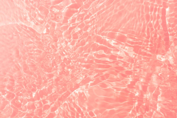 istock Pink water bubbles on the surface ripples. Defocus blurred transparent pink colored clear calm water surface texture with splash and bubbles. Water waves with shining pattern texture background 2150621194