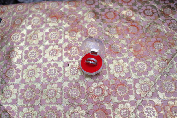 a pair of engagement rings placed in red ring container