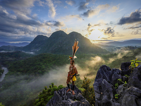 Sunrise on Langara Hill. Men from the Dayak Tribe of Kalimantan are dancing in the Meratus Mountains