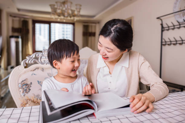 istock Mother and son reading together at a desk 2150627459