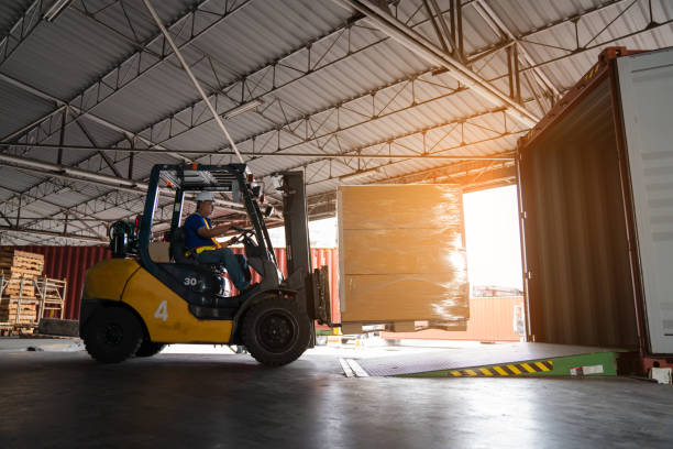 istock Warehouse worker driver in uniform delivery and loading pallet product. 2150628347