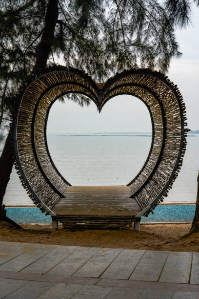 istock Heart-shaped wooden platform building on the beach by the sea 2150628607