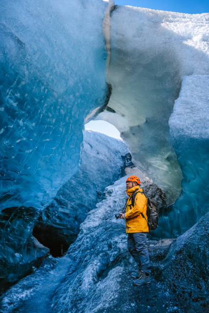 istock Asian Chinese mature man exploring Ice Cave in Iceland 2150629759