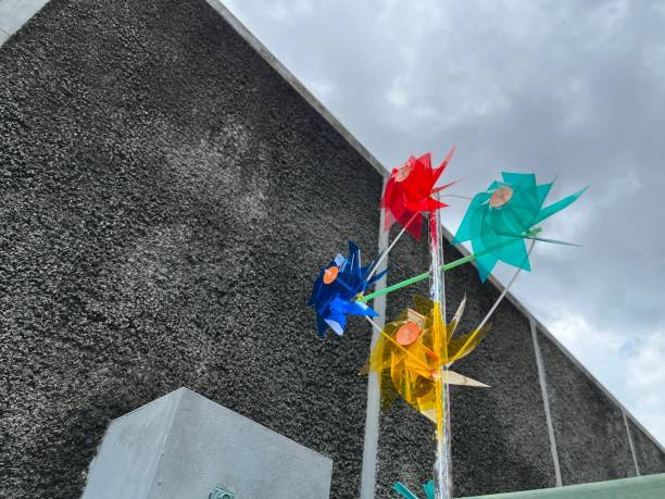 istock Windmill toys spinning in the wind under the sky 2150630375