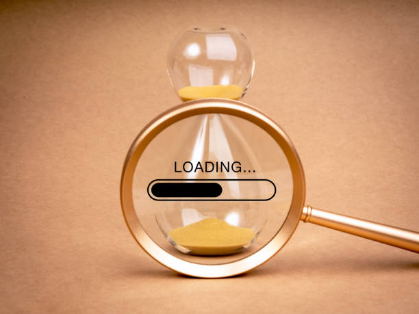 istock Loading update concept. Word Loading... with bar on simple hourglass in magnifying glass lens on beige recycle paper background, minimal style. Setting a time limit, mini-deadline to work. 2150631896
