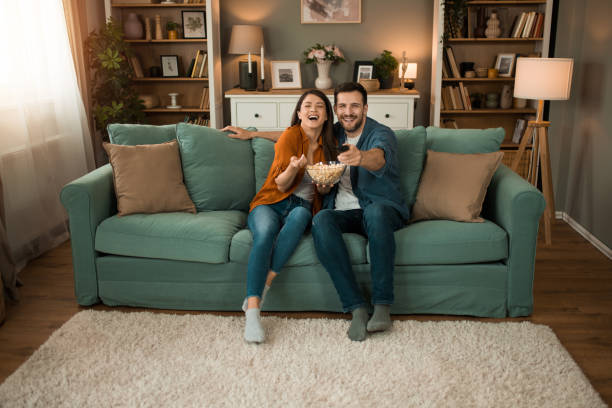 Couple watching a movie at home.