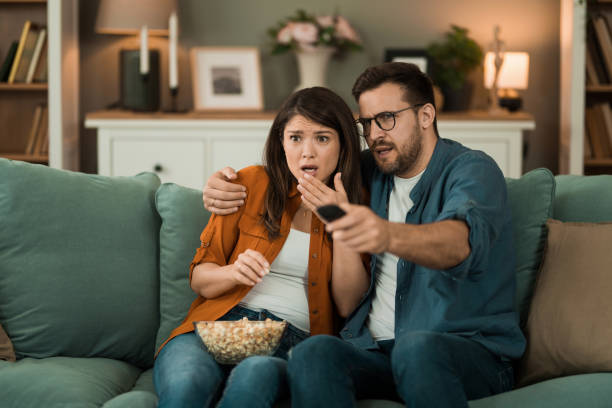 istock Scared couple watching a movie at home. 2150634285