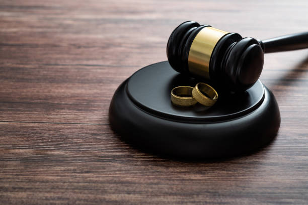 istock Wedding rings and gavel on wooden table 2150634666