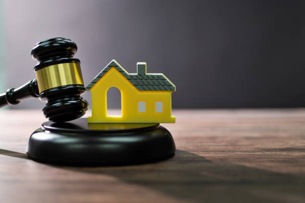 istock Gavel and model house on the table 2150634682