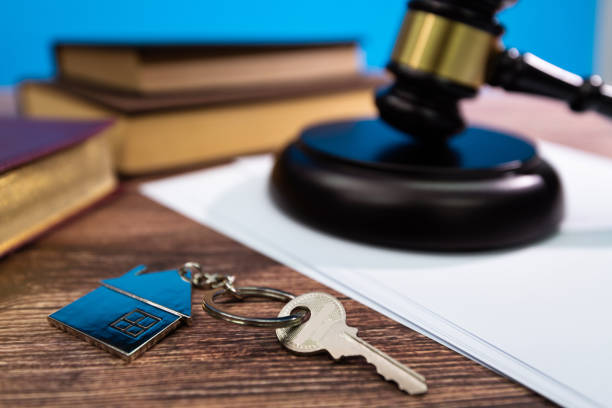 Gavel and house key on the table.