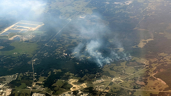 An aerial snapshot of smoke rising from a grassy area near the city of Orlando in Florida.
