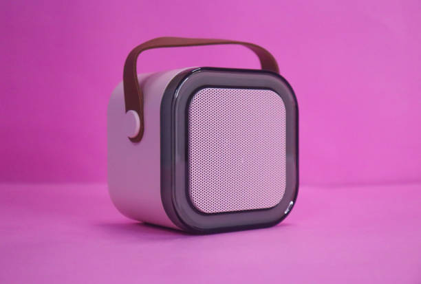 istock Small Speaker With Brown Hanging Belt On The Pink Background 2150635449