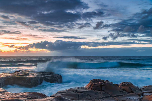 istock Sunrise, sea, waves, clouds and tessellated rock platform 2150636477