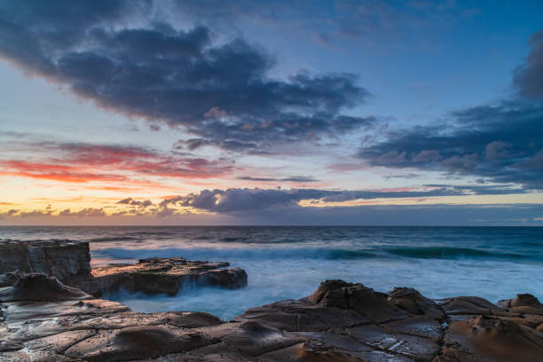 istock Sunrise, sea, waves, clouds and tessellated rock platform 2150636501