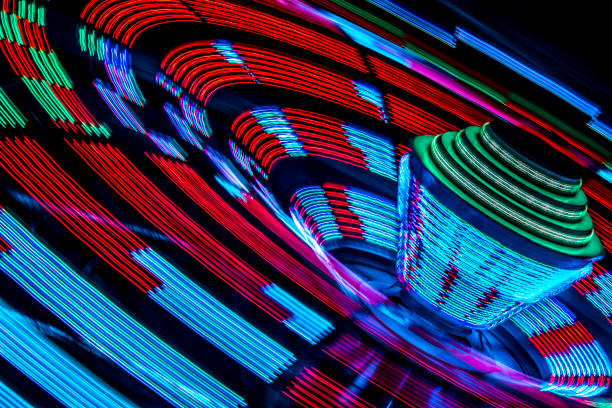 istock Carnival Ride Produces Colorful Patterns at Night at Annual Fire Department Summer Carnival 2150638024
