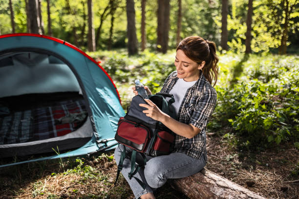 istock Attractive Woman Enjoying Nature's Beauty with Backpack by Tent 2150638549