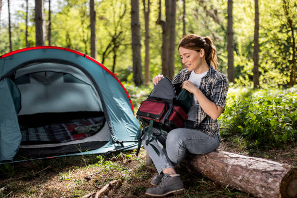 istock Attractive Young Woman Resting in Front of Tent with Backpack 2150638550