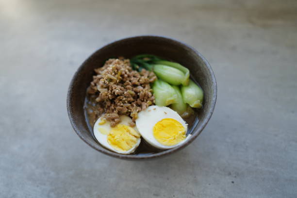 Ramen asian noodle in broth with Beef on a concrete background