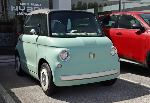 New Fiat Topolino,  electric micro car, outside the official dealership. Tavagnacco, Italy. April 28, 2024. New Fiat Topolino, all electric quadricycle of  the italian automaker, outside the official dealership. fiat 500 topolino stock pictures, royalty-free photos & images