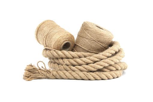 Collection of various rolls of natural jute rough rope and twine isolated on white background