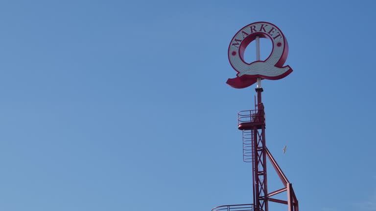 Rotating Q Sign At Lonsdale Quay Market In North Vancouver, British Columbia, Canada. Low Angle Shot