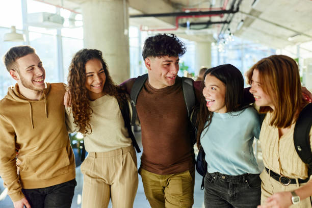 istock Happy college students walking embraced through campus. 2150643134