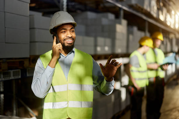 istock Happy black manager talking on cell phone in distribution warehouse. 2150643857