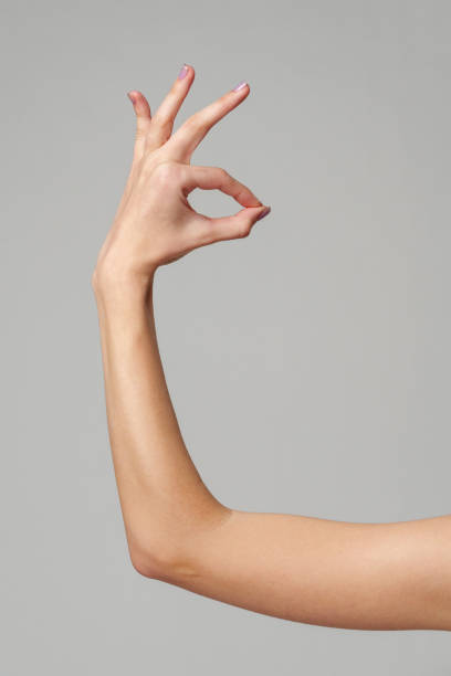 istock Female hand showing OK sign on gray background 2150643886