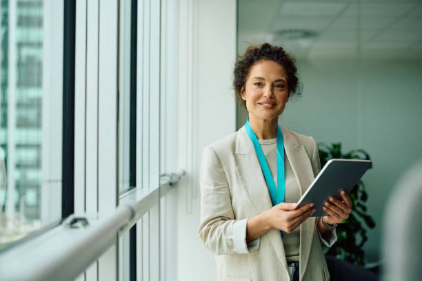 istock Happy businesswoman working on digital tablet and looking at camera. 2150644428