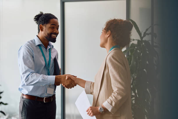 istock Happy business colleagues shaking hands while meeting in the office. 2150644557