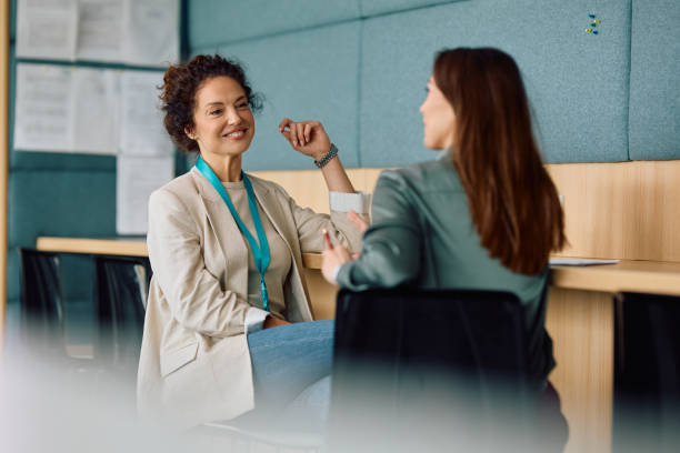 istock Happy female colleagues talking on a break in the office. 2150644626