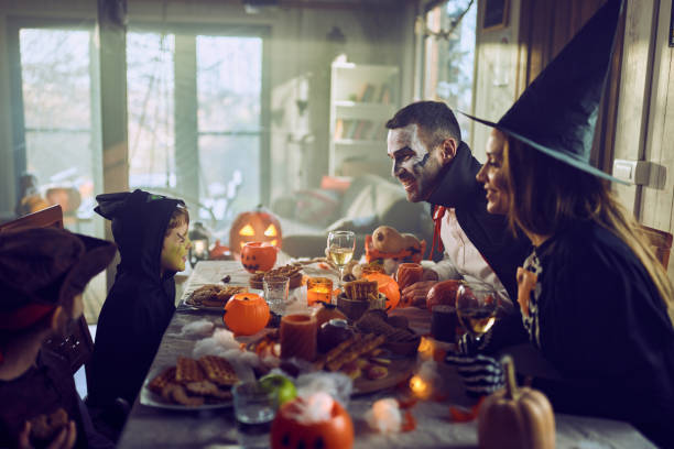 istock Happy family talking on Halloween at dining table. 2150644696