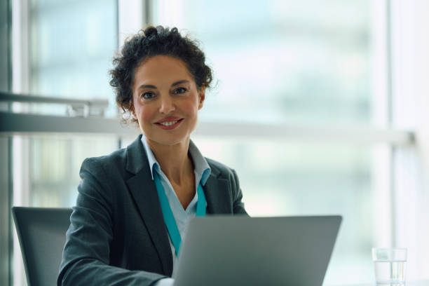 istock Smiling financial advisor working on laptop in her office and looking at camera. 2150644742