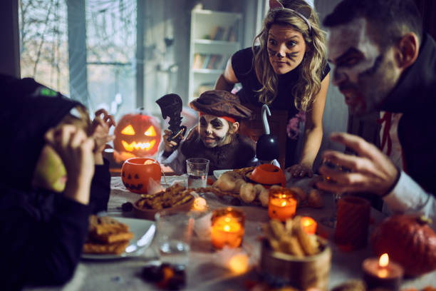 istock Carefree family having fun on Halloween at dining table. 2150645104