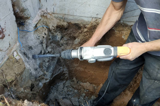 istock jackhammer in action, pneumatic construction tool, drilling a hole in the concrete wall. 2150645224