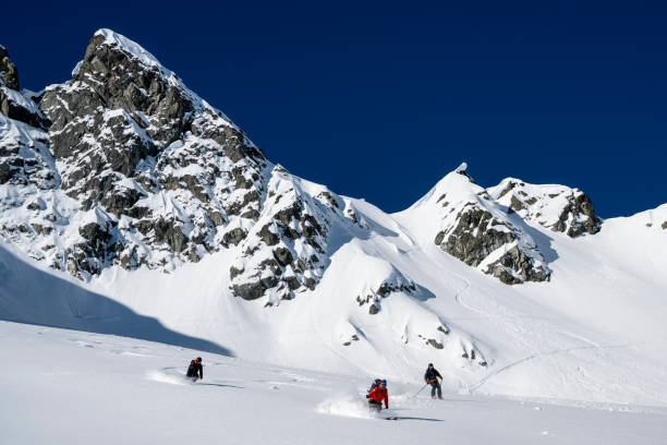 istock Group of ski mountaineers descend slope 2150645231
