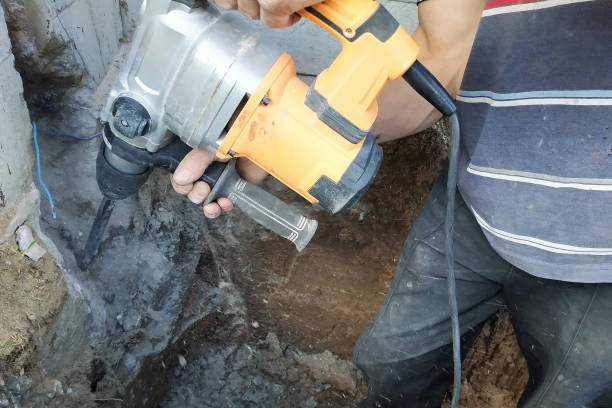 istock Construction industry worker using pneumatic hammer drill to cut the wall concrete brick, close up 2150645232