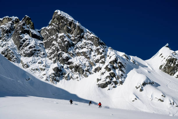 istock Group of ski mountaineers descend slope 2150645291