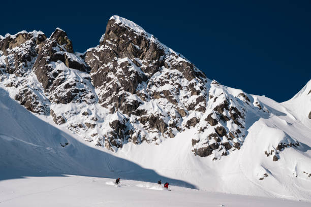istock Group of ski mountaineers descend slope 2150645313