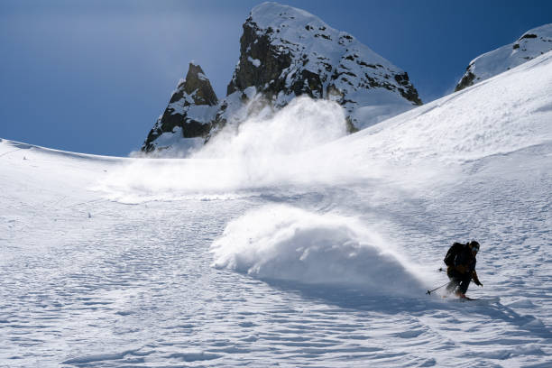 istock Ski mountaineer descends mountain slope 2150645476