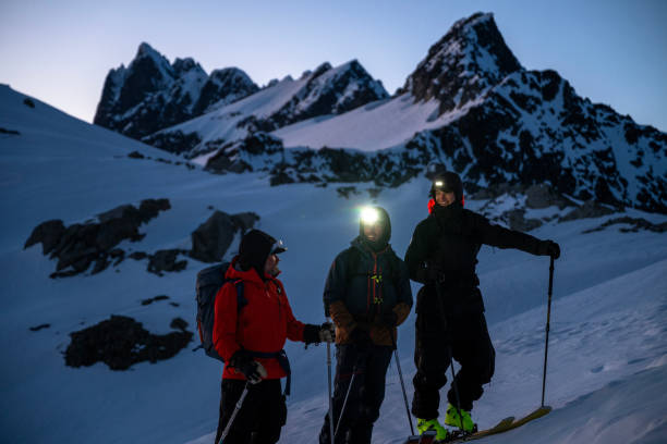 istock Group of ski mountaineers pause on mountain at twilight 2150645498