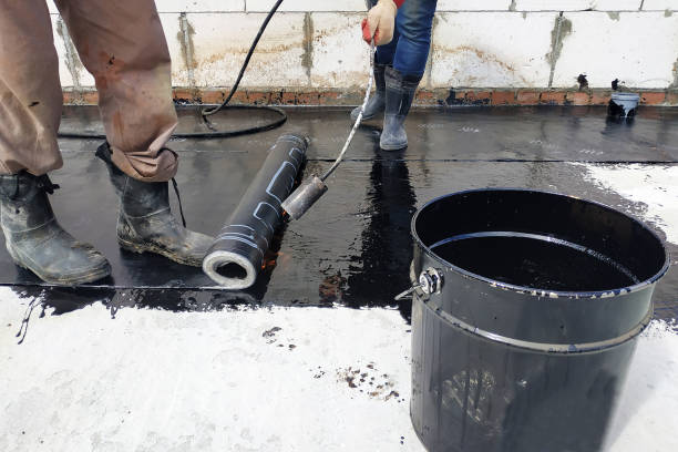 istock The workers cover the concrete screed with bituminous liquid solution and stele the waterproofing. 2150646060