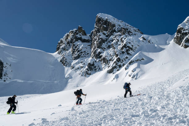 istock Ski mountaineers climb mountain 2150646311